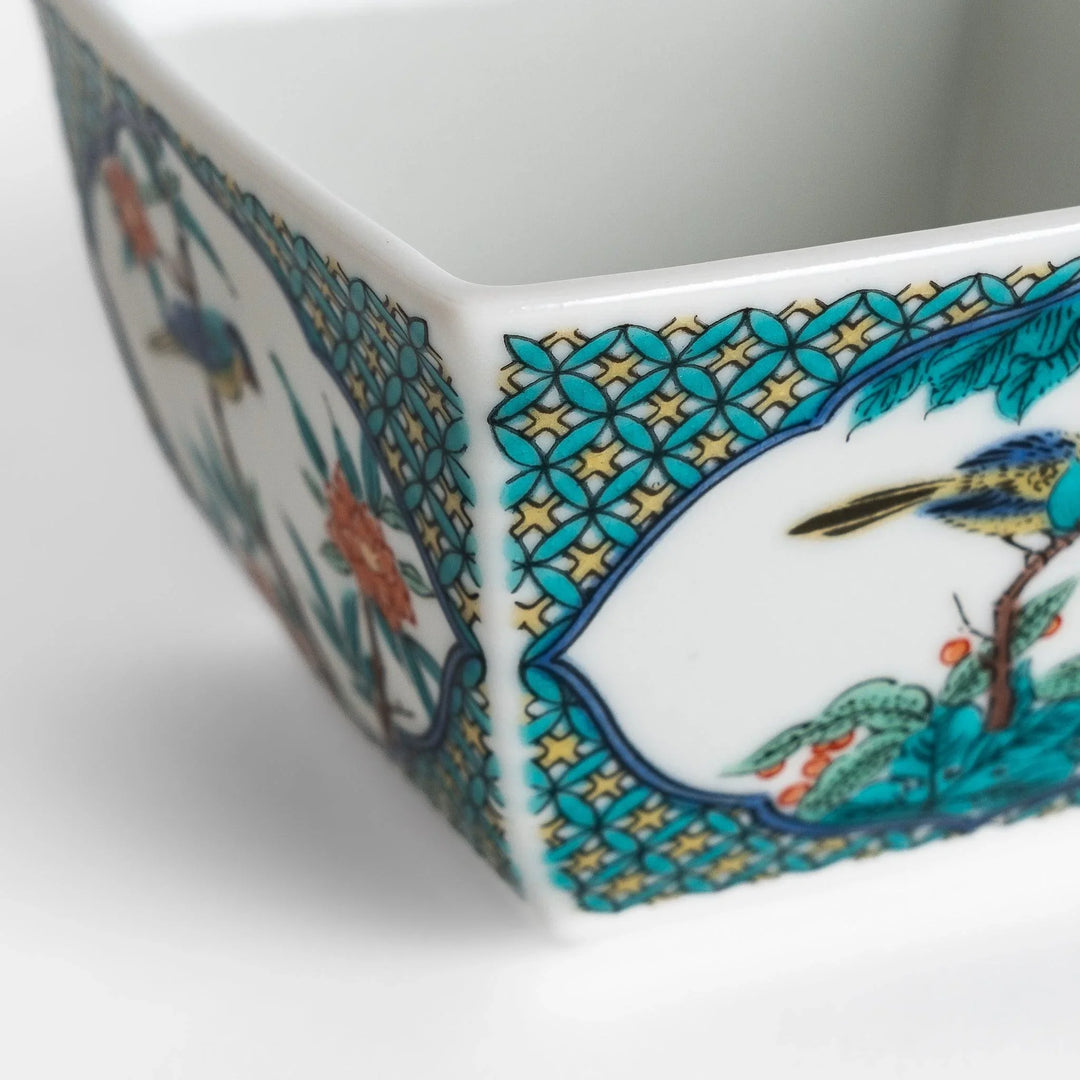 Traditional flower and bird design adorns this elegant condiment bowl, framed with intricate blue patterns.