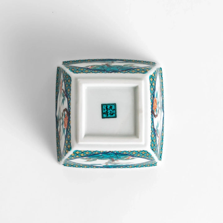 Traditional flower and bird design adorns this elegant condiment bowl, framed with intricate blue patterns.