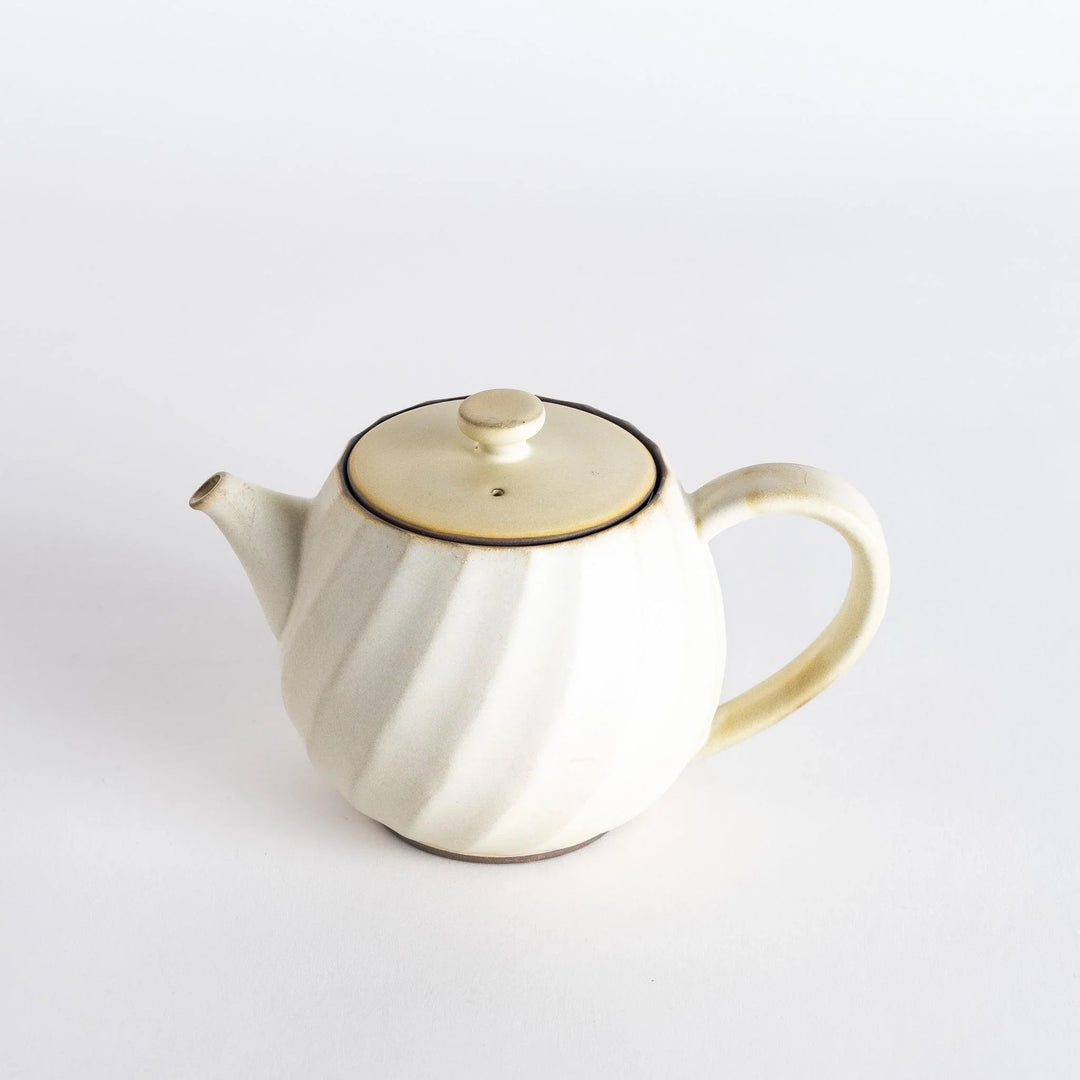 Elegant teapot featuring a subtle swirl design and a matching lid, perfect for serving your favorite tea.