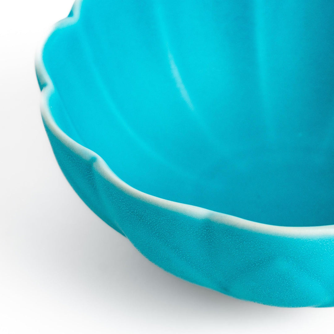 Turkish blue lotus-shaped dessert bowl with matte finish and white base, featuring delicate petal-like detailing.