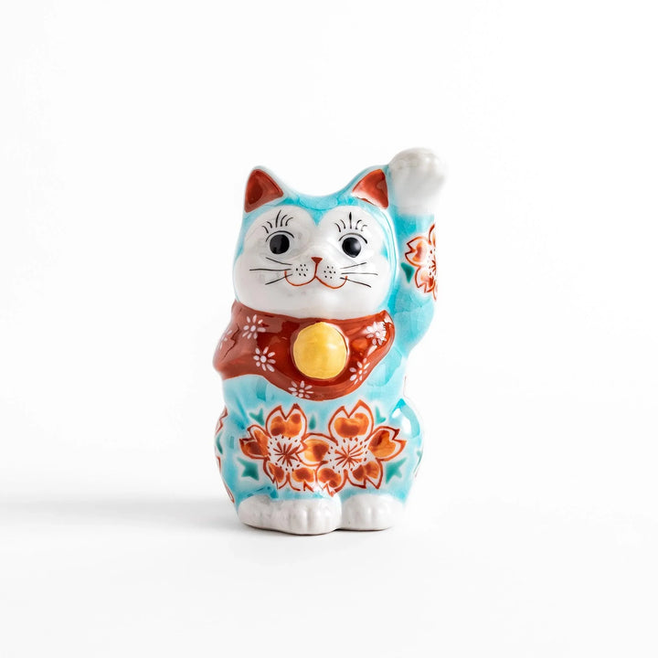 Turkish blue Japanese Maneki Neko figurine with floral patterns golden bell and raised paw for good fortune.