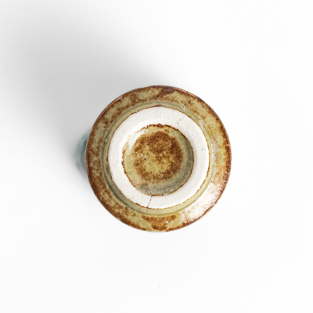 Turquoise sauce pourer with a smooth glaze and textured base, perfect for serving sauces or dressings.