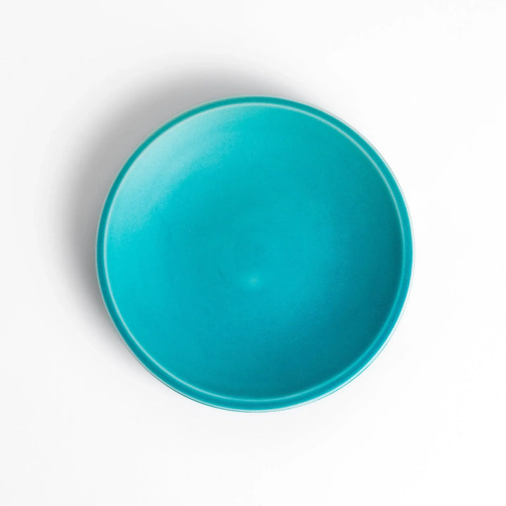 Turkish blue saucer with smooth matte finish and clean design, complementing a minimalist tea cup.