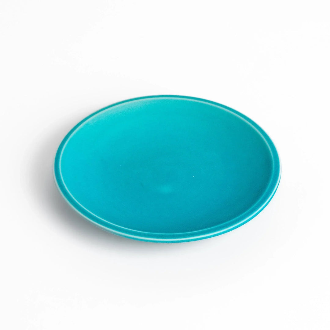 Turkish blue saucer with smooth matte finish and clean design, complementing a minimalist tea cup.