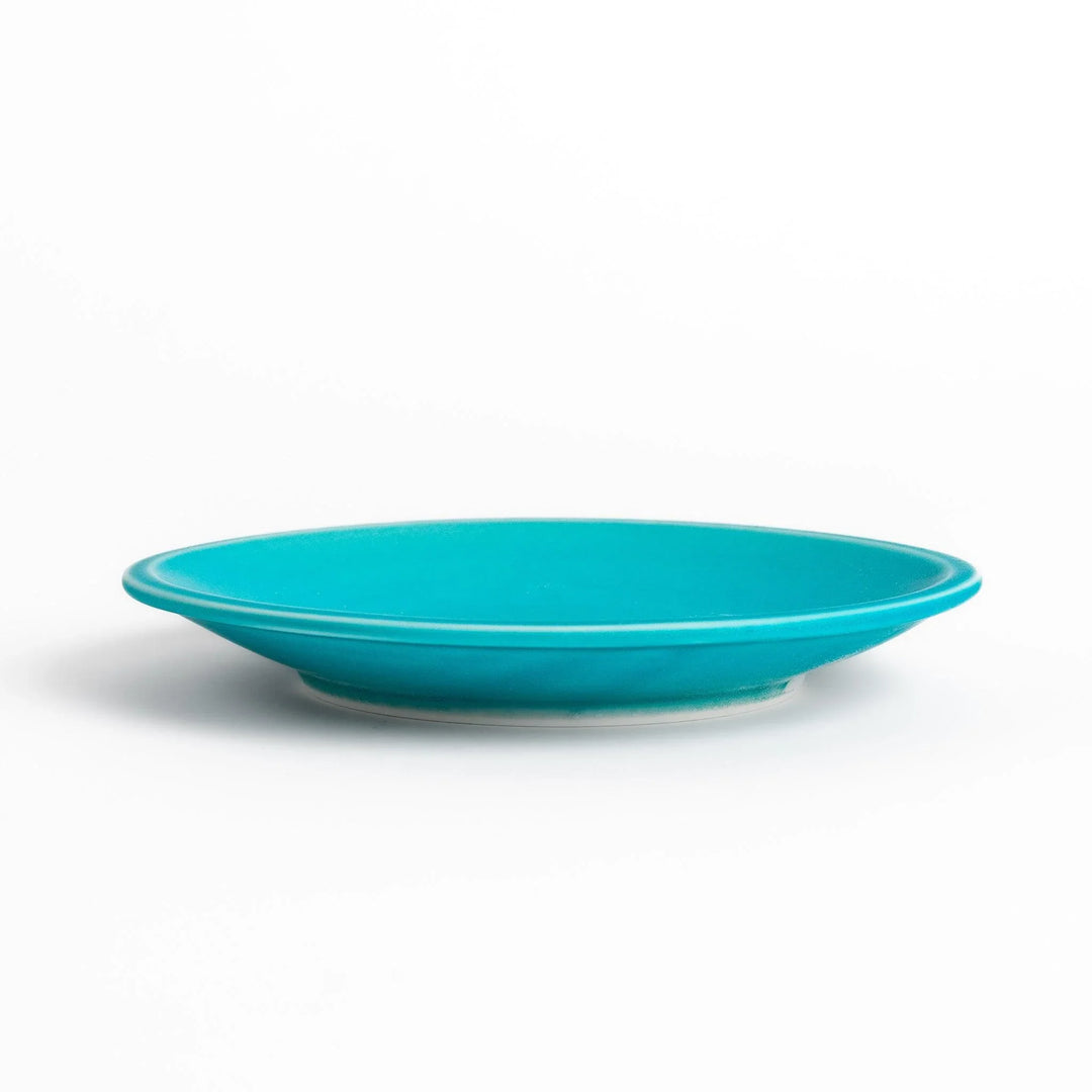Turkish blue saucer with smooth matte finish and clean design, complementing a minimalist tea cup.