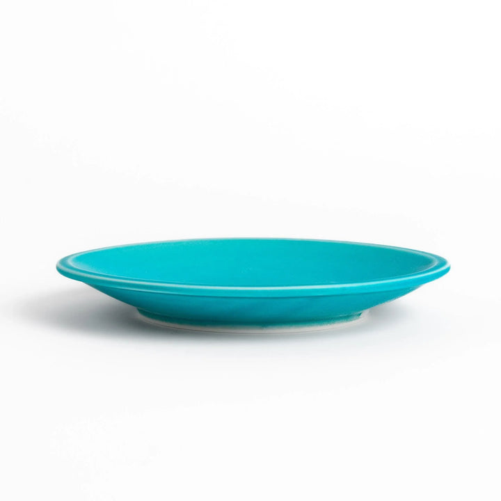 Turkish blue saucer with smooth matte finish and clean design, complementing a minimalist tea cup.