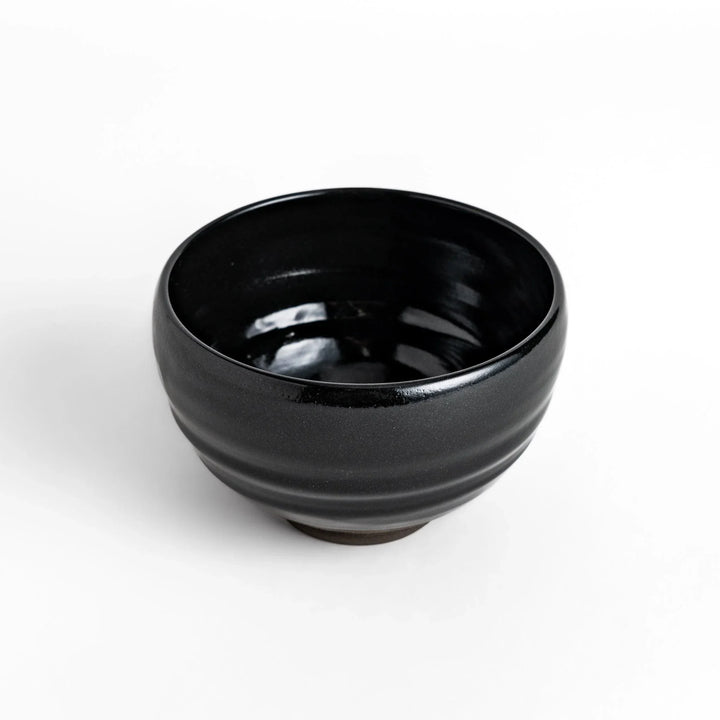 Elegant black ceramic Matcha bowl with a minimalist design, ideal for preparing and serving Matcha.