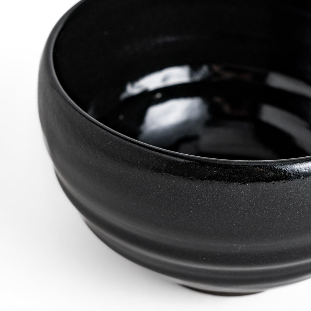 Elegant black ceramic Matcha bowl with a minimalist design, ideal for preparing and serving Matcha.