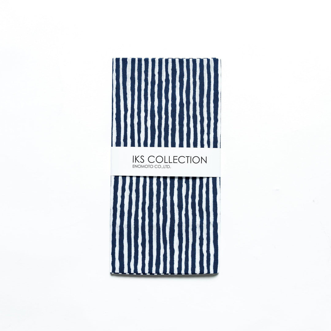 Navy hand towel with vertical white stripes, folded with a product sleeve.