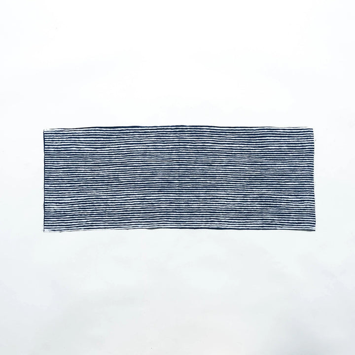 Navy hand towel with vertical white stripes, laid flat for full view.