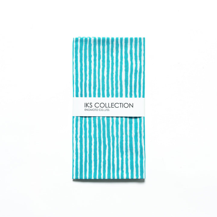 Bright blue hand towel with vertical white stripes, folded with a product sleeve.
