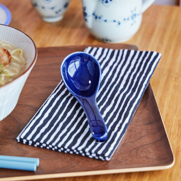 Black and white tenugui with hand-drawn stripe design, adding a modern Japanese touch to your dining presentation.