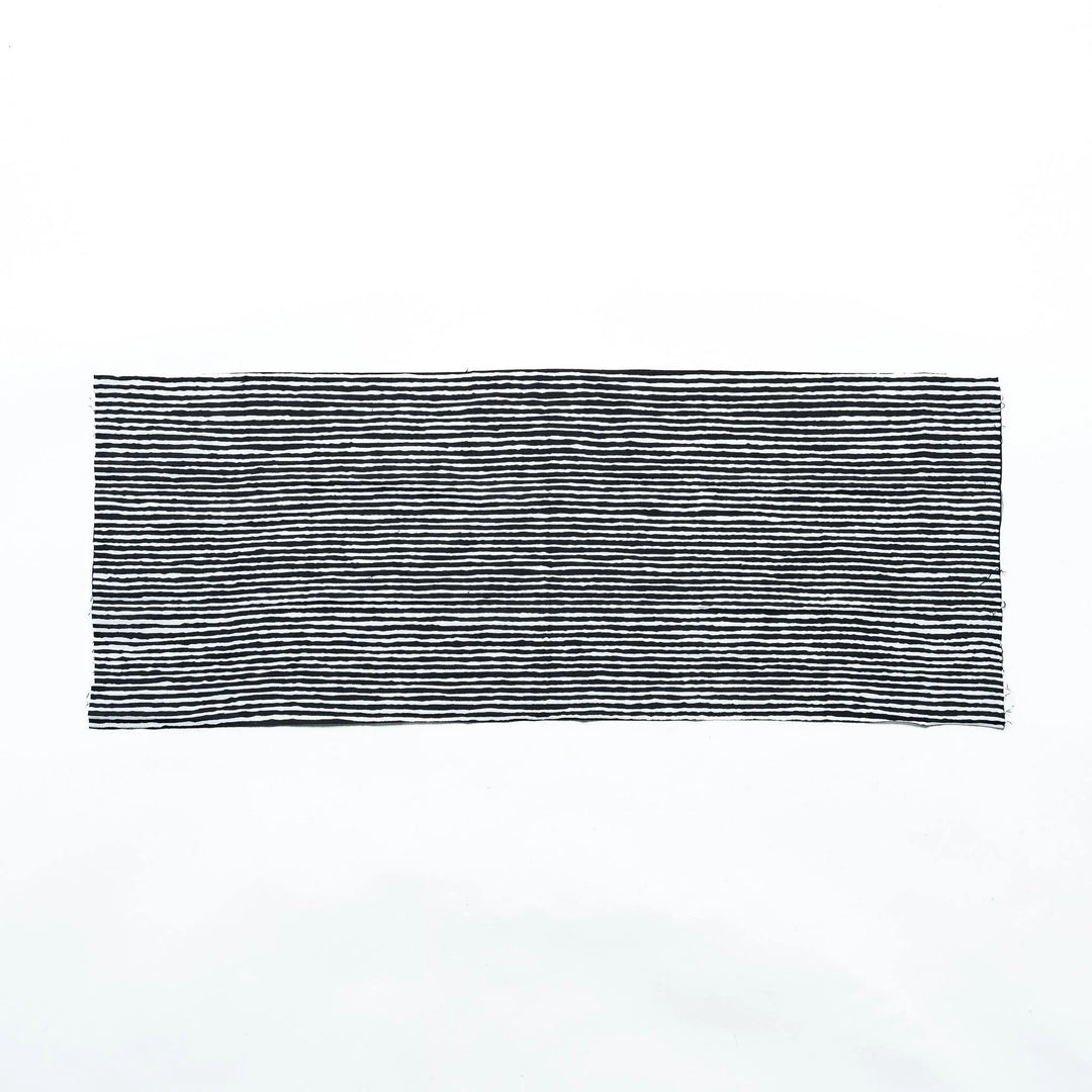 Black hand towel with vertical white stripes, laid flat for full view.