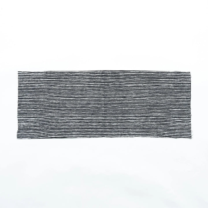 Black hand towel with vertical white stripes, laid flat for full view.