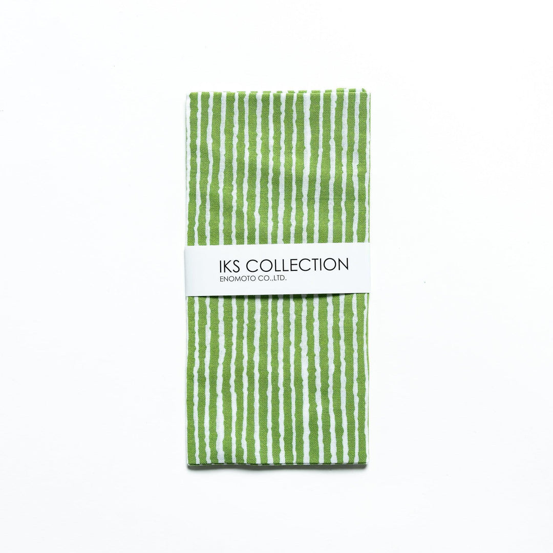 Green hand towel with vertical white stripes, folded with a product sleeve.