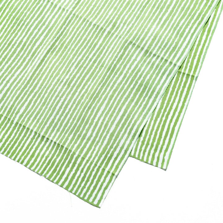 Close-up of the green hand towel's vertical white stripe pattern.
