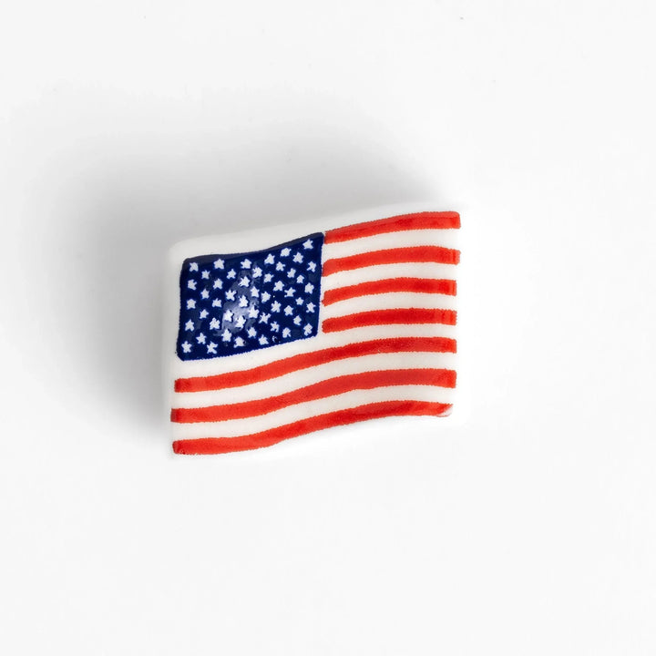 Chopstick rest shaped like the United States flag, featuring red and white stripes with a blue field of white stars.