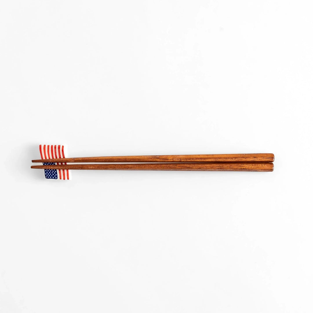 Chopstick rest shaped like the United States flag, featuring red and white stripes with a blue field of white stars.