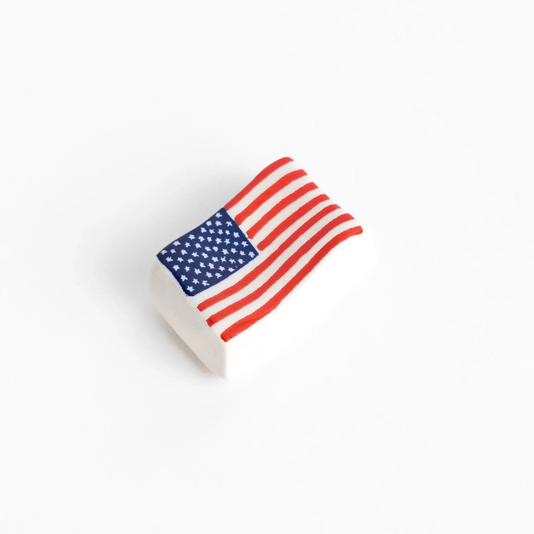 Chopstick rest shaped like the United States flag, featuring red and white stripes with a blue field of white stars.