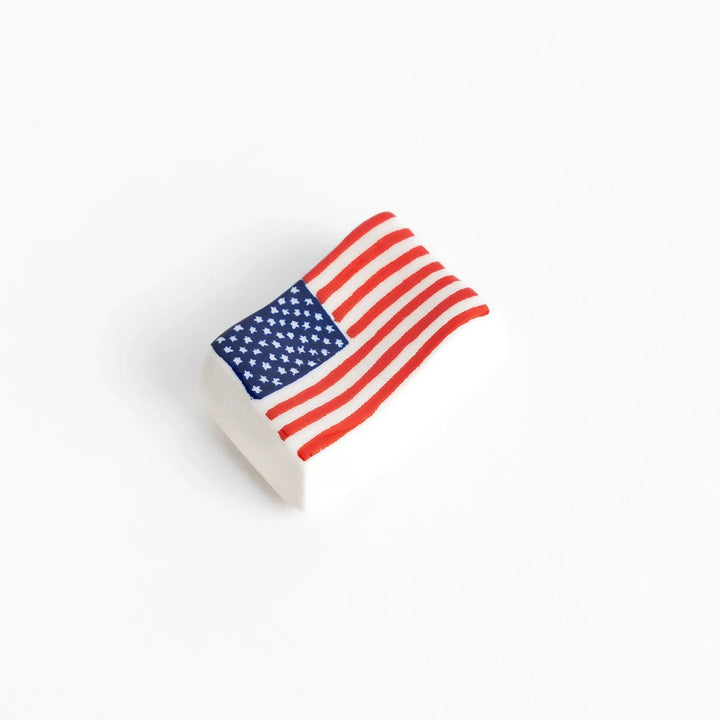 Chopstick rest shaped like the United States flag, featuring red and white stripes with a blue field of white stars.