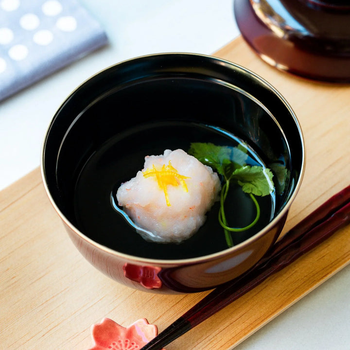 Ebi Shinjo shrimp and vegetable soup served in a traditional red bowl with citrus zest for refined dining.