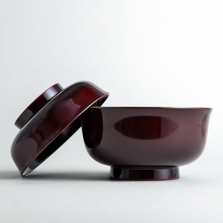 Glossy lacquer soup bowl with matching lid and gold rim available in black or red for elegant serving.