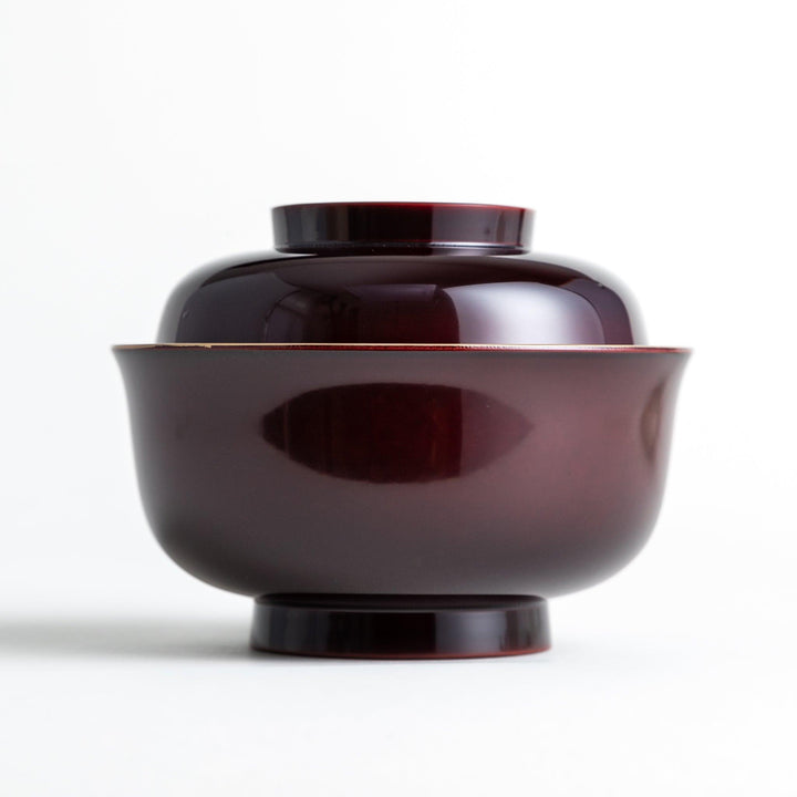 Glossy lacquer soup bowl with matching lid and gold rim available in black or red for elegant serving.