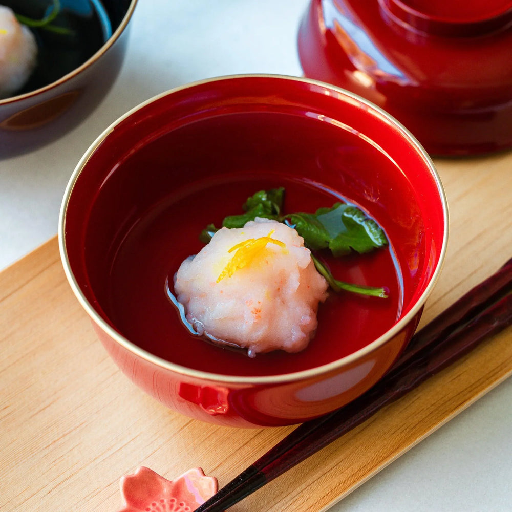 Ebi Shinjo shrimp and vegetable soup served in a traditional red bowl with citrus zest for refined dining.