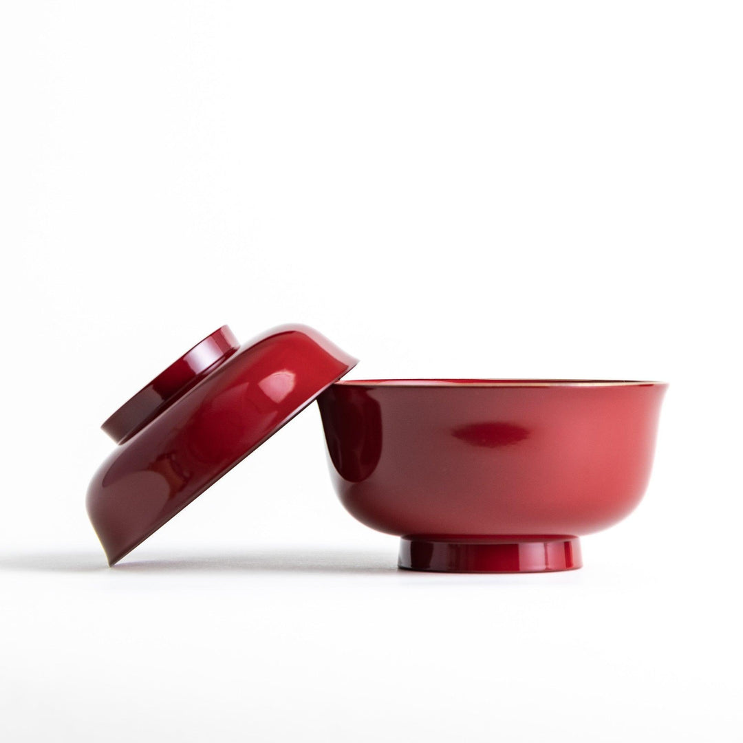 Glossy lacquer soup bowl with matching lid and gold rim available in black or red for elegant serving.