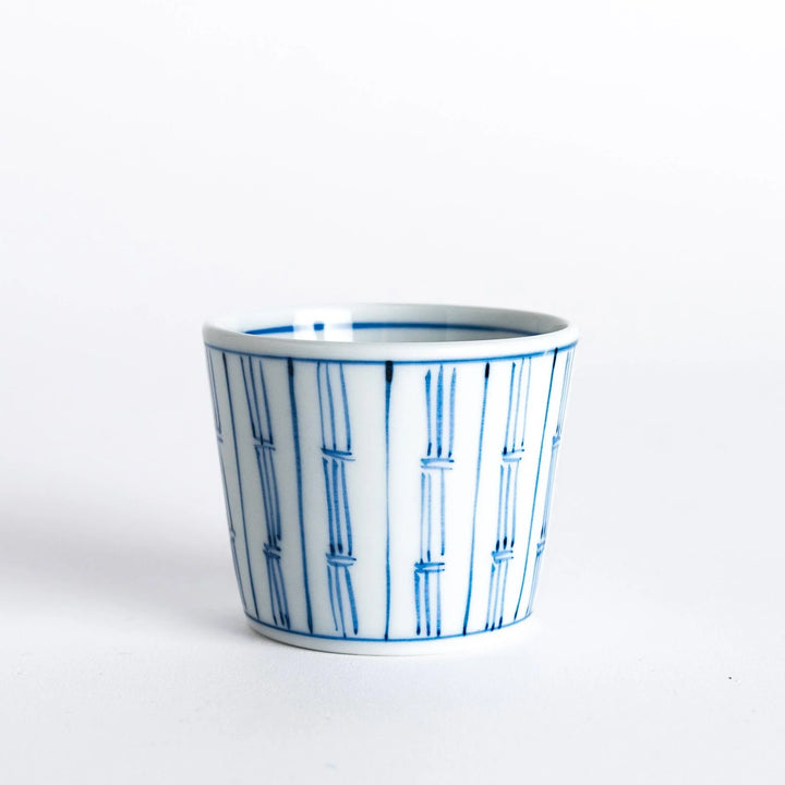 White bowl with blue vertical bamboo line pattern, showcasing the clean, minimalist design of the bowl.