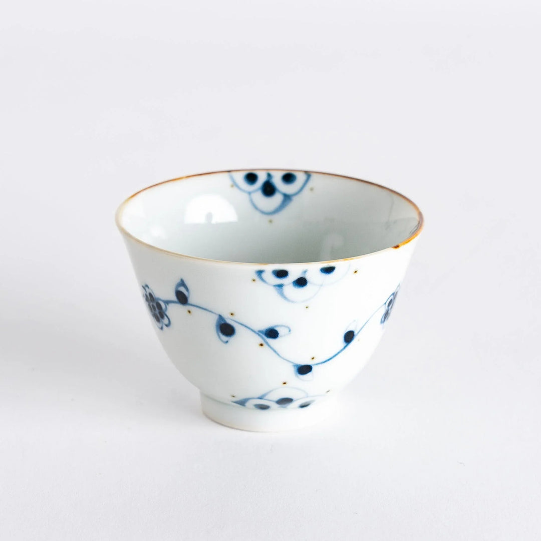 Vintage vine flower teacup featuring intricate blue floral patterns on a white background, perfect for tea service.