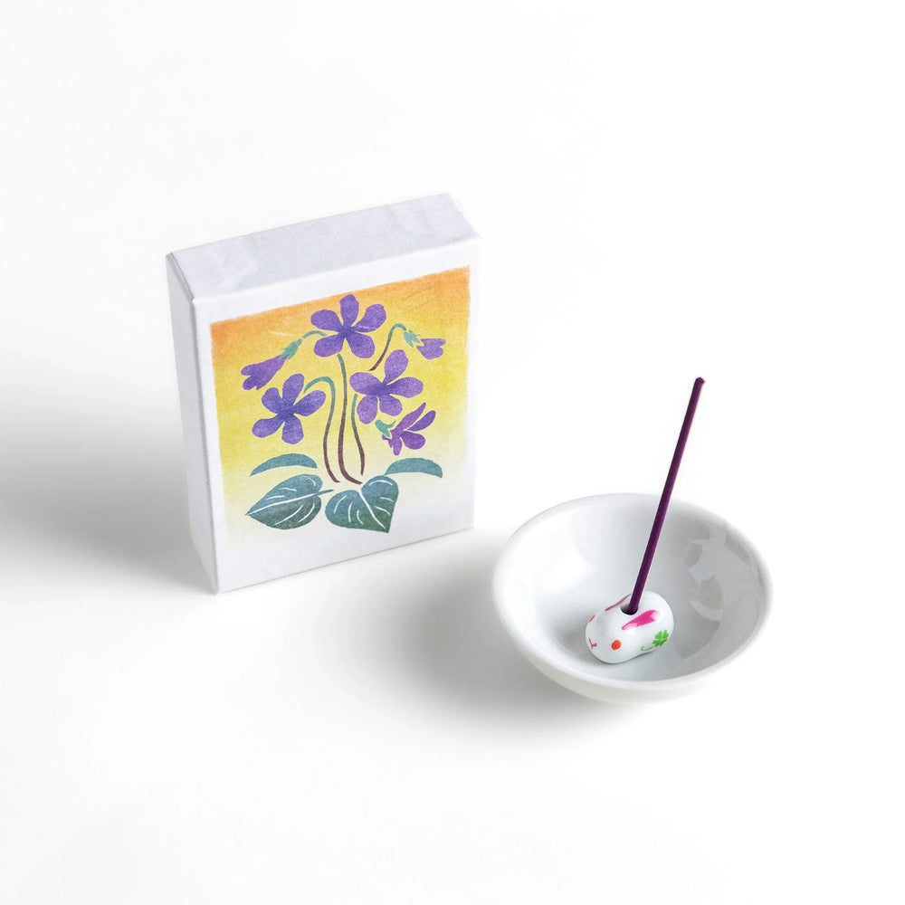 Incense with violet sticks in a box with violet flower design offering a floral soothing fragrance for relaxation.