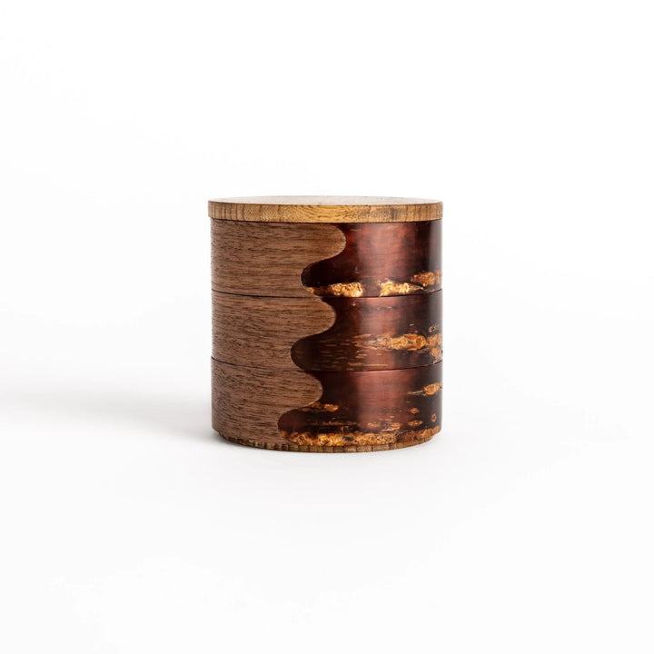 Walnut and cherry bark jewelry case with wavy design perfect for storing small accessories elegantly.