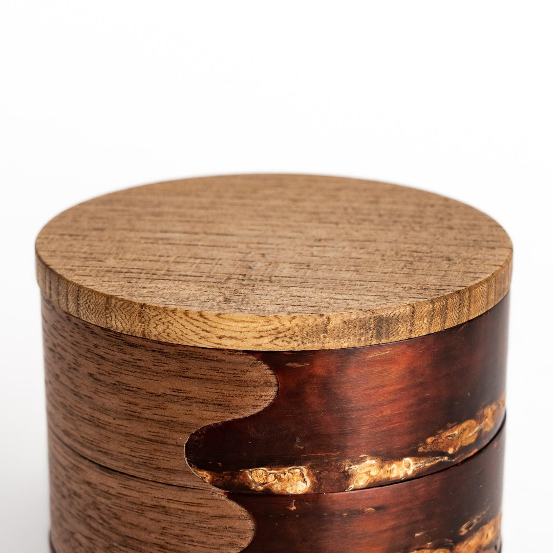 Walnut and cherry bark jewelry case with wavy design perfect for storing small accessories elegantly.