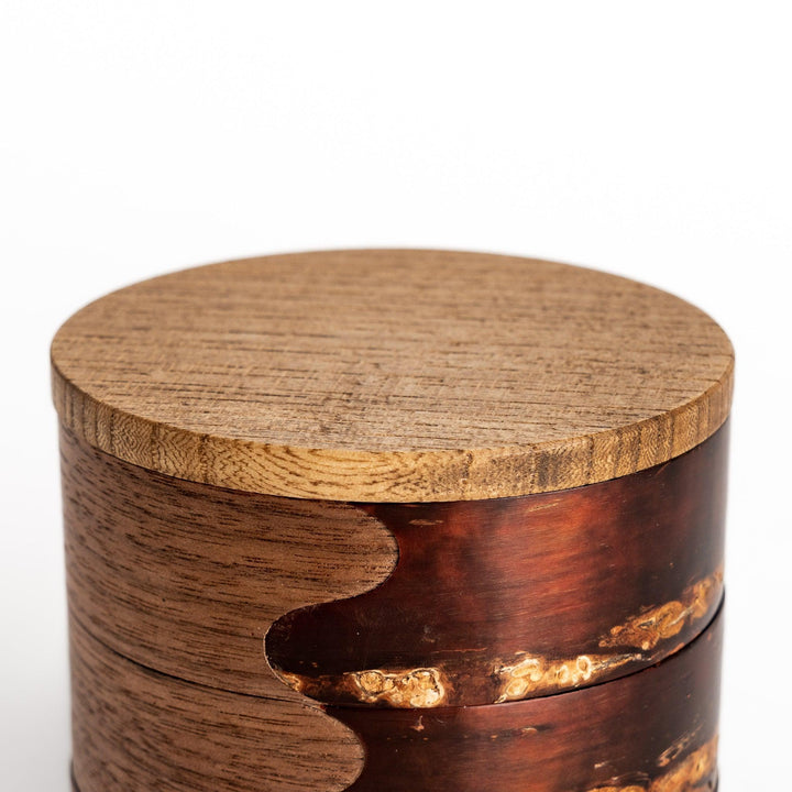 Walnut and cherry bark jewelry case with wavy design perfect for storing small accessories elegantly.
