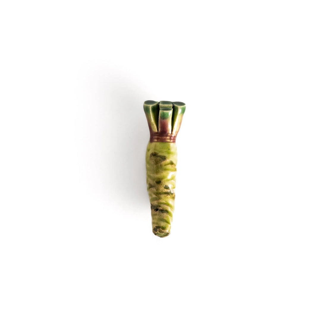 Green ceramic wasabi chopstick rest with textured root design mimicking authentic Japanese wasabi shape.