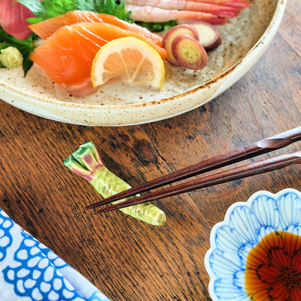 Green ceramic wasabi chopstick rest with textured root design mimicking authentic Japanese wasabi shape.
