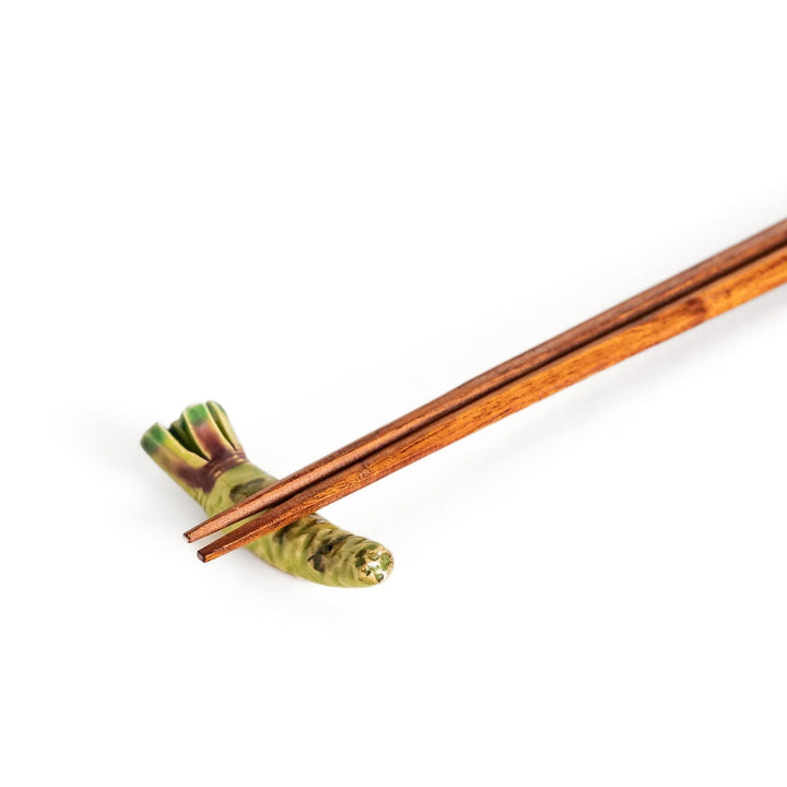 Green ceramic wasabi chopstick rest with textured root design mimicking authentic Japanese wasabi shape.