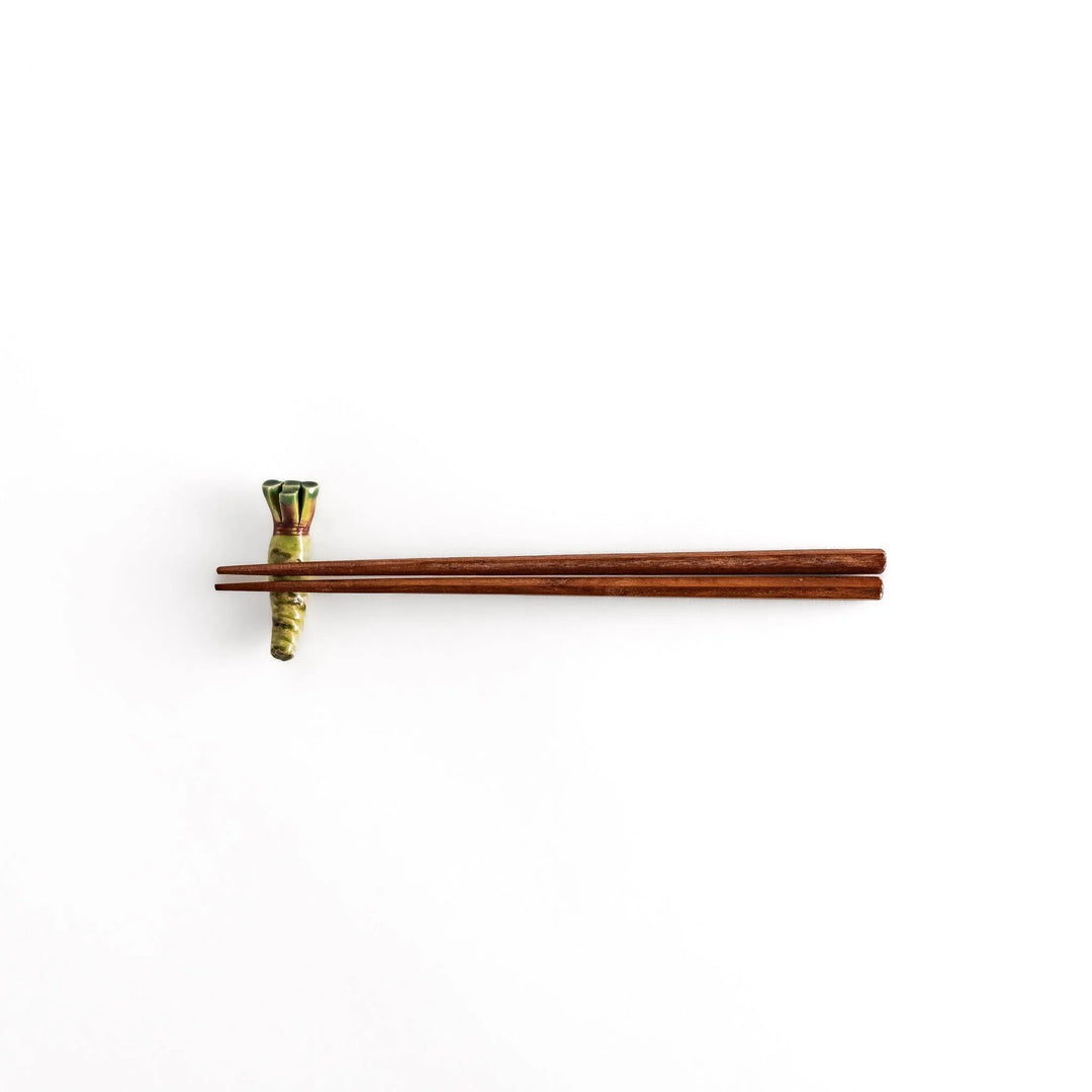 Green ceramic wasabi chopstick rest with textured root design mimicking authentic Japanese wasabi shape.