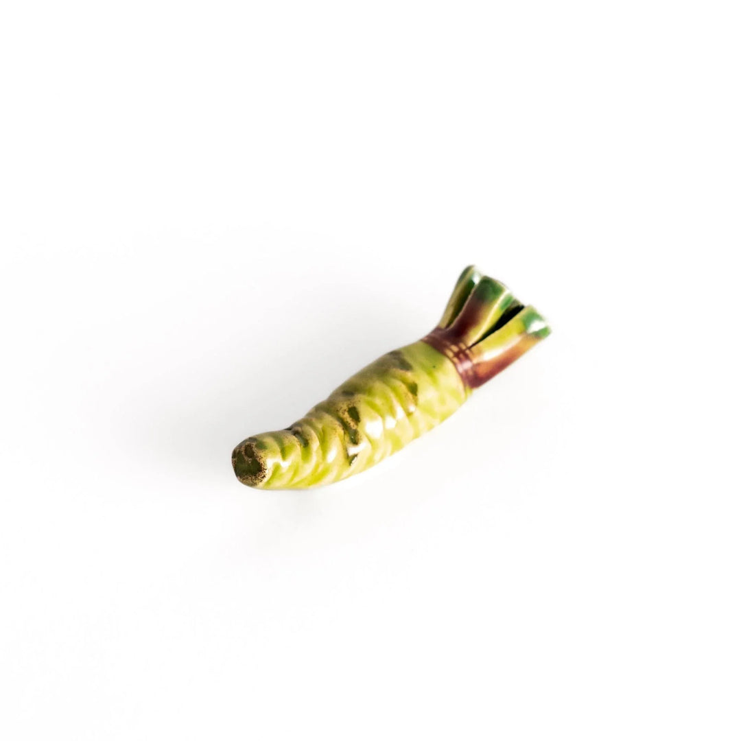 Green ceramic wasabi chopstick rest with textured root design mimicking authentic Japanese wasabi shape.