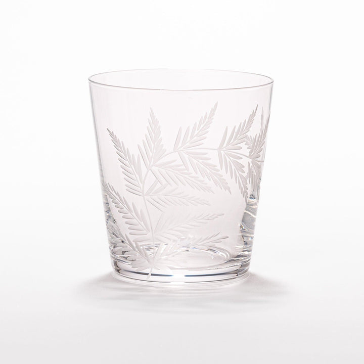 Rocks glass with delicate fern engravings, ideal for serving whiskey or fine drinks in refined style.