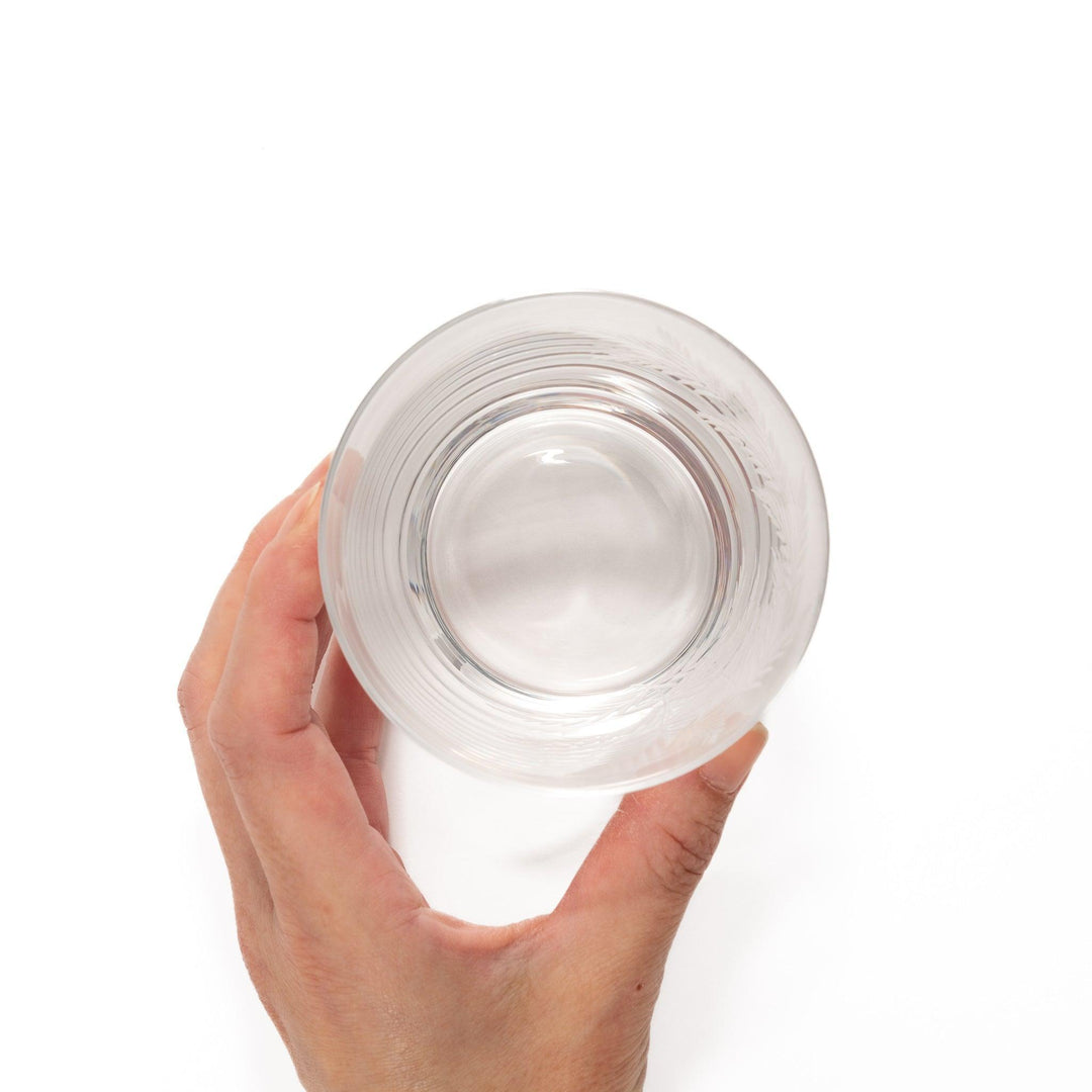 Rocks glass with delicate fern engravings, ideal for serving whiskey or fine drinks in refined style.