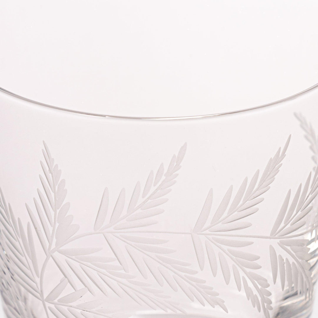 Rocks glass with delicate fern engravings, ideal for serving whiskey or fine drinks in refined style.