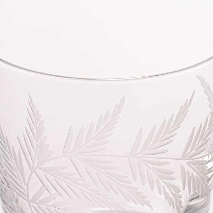 Rocks glass with delicate fern engravings, ideal for serving whiskey or fine drinks in refined style.