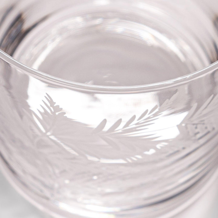 Rocks glass with delicate fern engravings, ideal for serving whiskey or fine drinks in refined style.