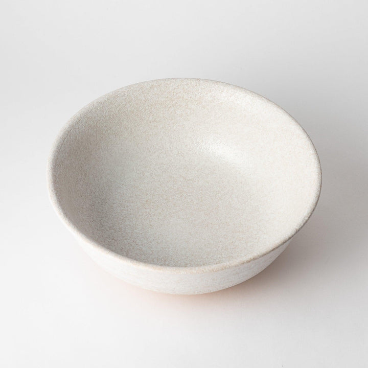 A bowl with a textured, speckled white glaze and a natural, earthy appearance.