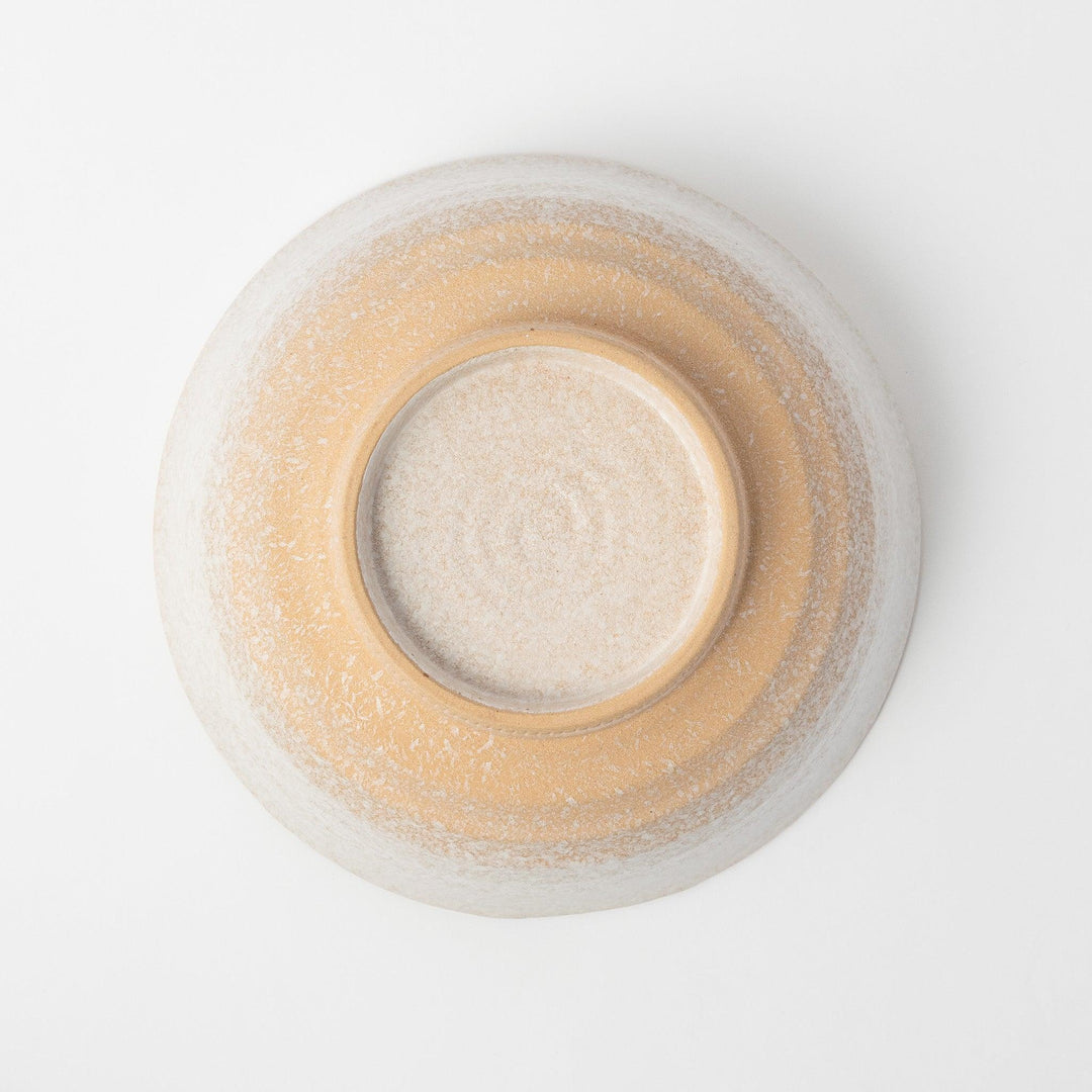 A bowl with a textured, speckled white glaze and a natural, earthy appearance.