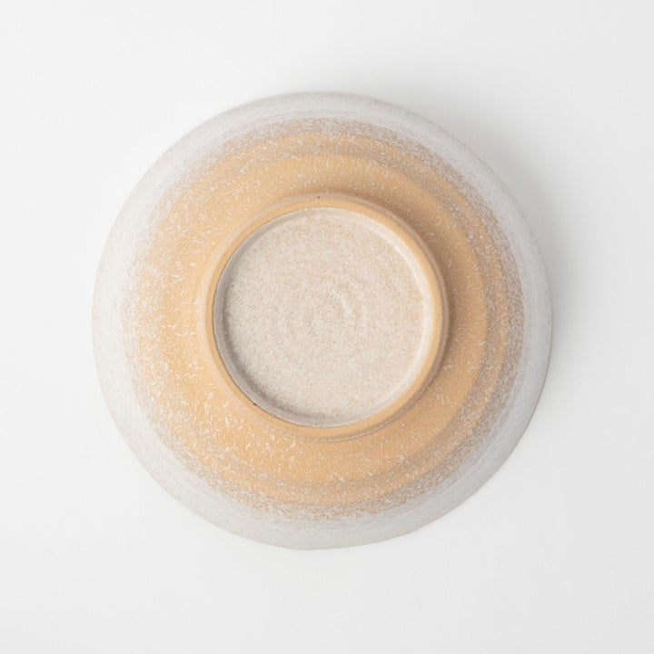 A bowl with a textured, speckled white glaze and a natural, earthy appearance.