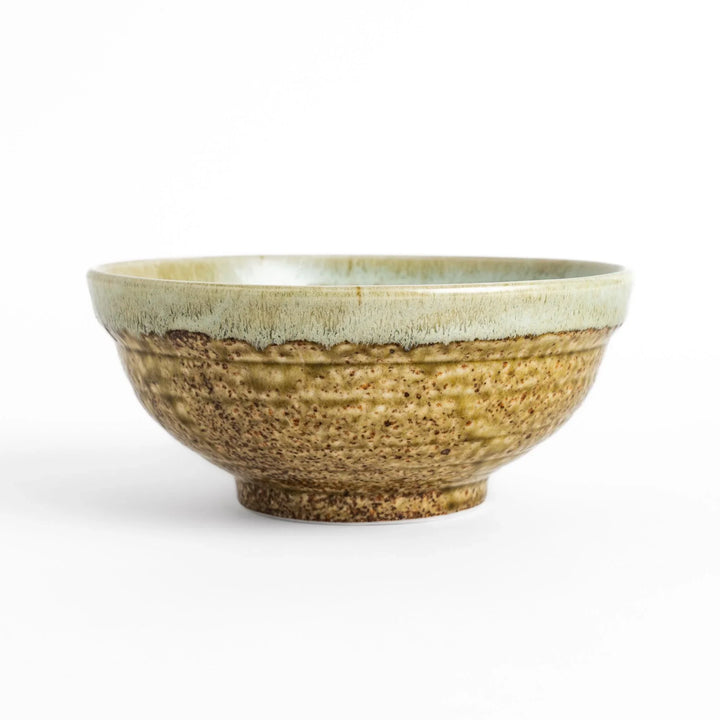 Ramen bowl featuring a beautiful white drip glaze over an earthy, textured base, combining natural tones of brown and green.