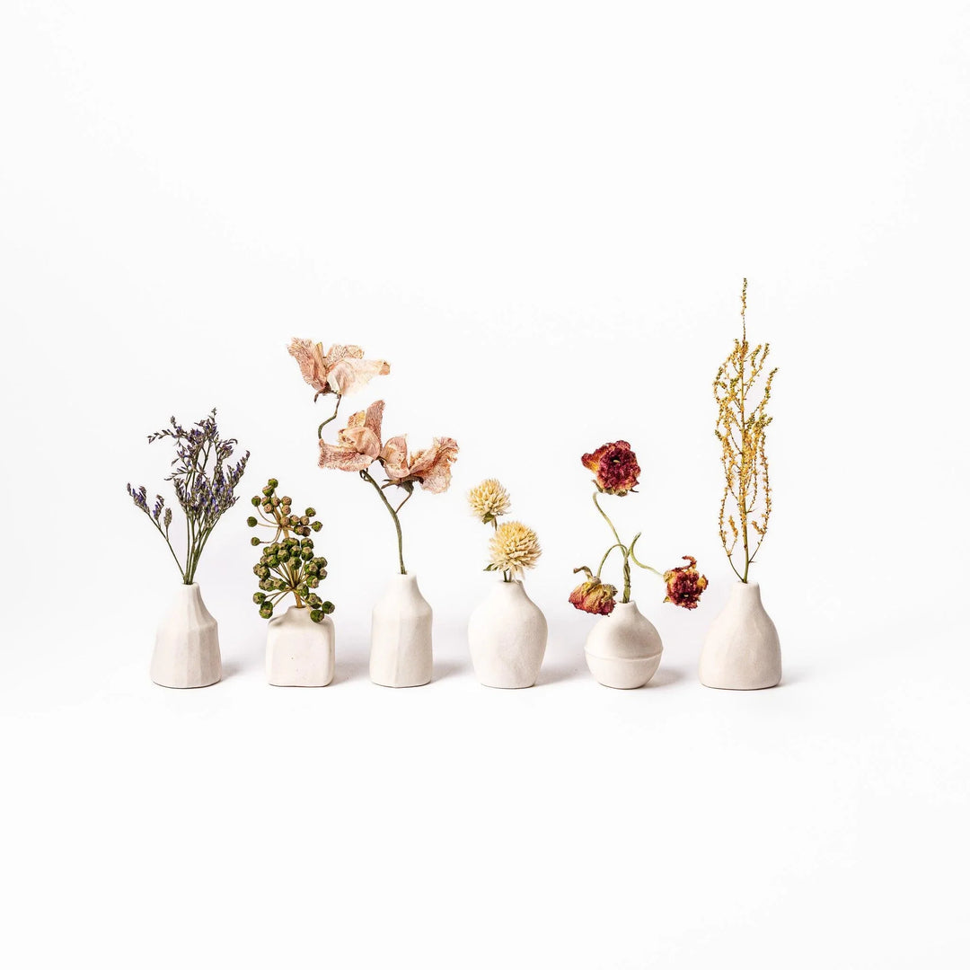 White ceramic bud vase with dried flowers, perfect for adding simple, elegant Japanese-inspired decor to any space.